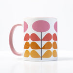 1959s mid century modern pink flowers on a white background coffee mug. Has ombre orange to yellow leaves. Inside of mug is pink, and the handle is also pink.