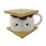 This photo shows the front of the mug. Mug is a large marshmallow with a kawaii face, chocolate on top of the marshmallow, and two graham crackers. Top graham cracker is the lid of the mug