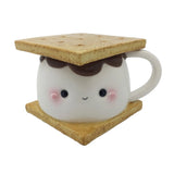 This photo shows the front of the mug. Mug is a large marshmallow with a kawaii face, chocolate on top of the marshmallow, and two graham crackers. Top graham cracker is the lid of the mug
