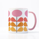1959s mid century modern pink flowers on a white background coffee mug. Has ombre orange to yellow leaves. Inside of mug is pink, and the handle is also pink.