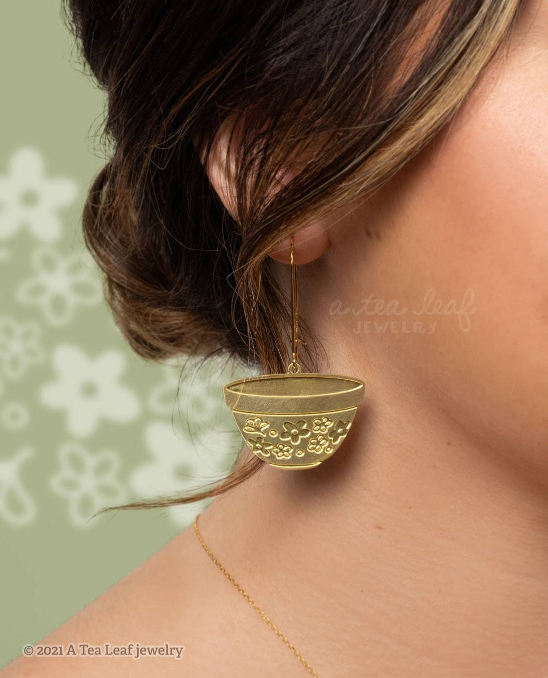 Model wearing gold earrings