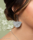 Model wearing silver earrings