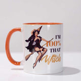 Witch pinup on broom. Orange and black lettering stating "I'm 100% that witch".