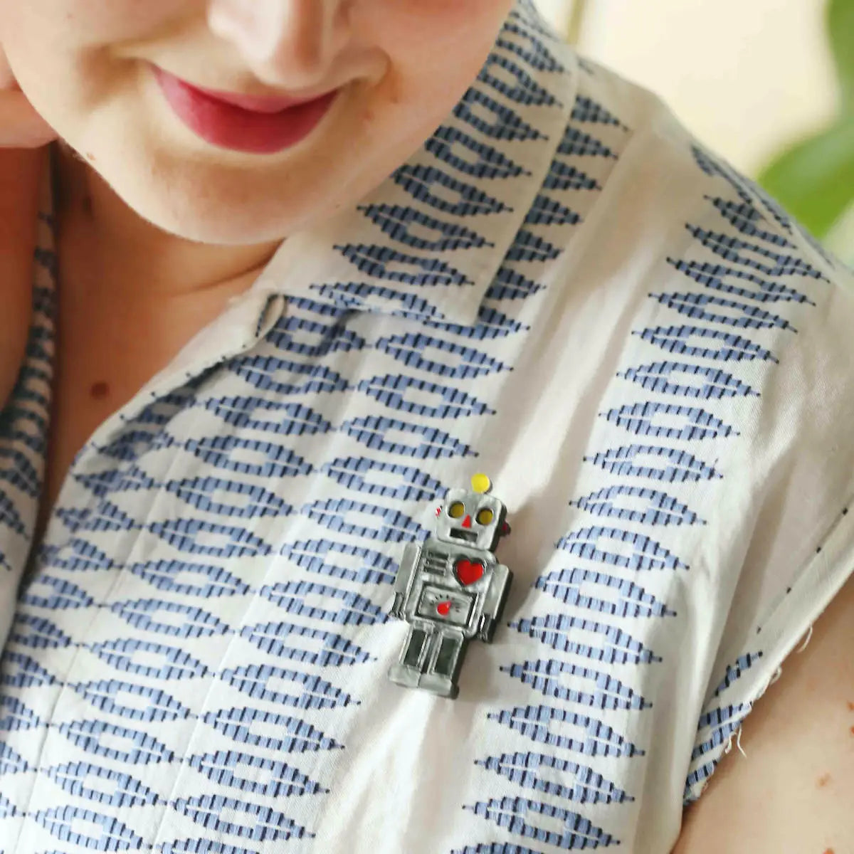 Brooch shown worn on a white and blue blouse