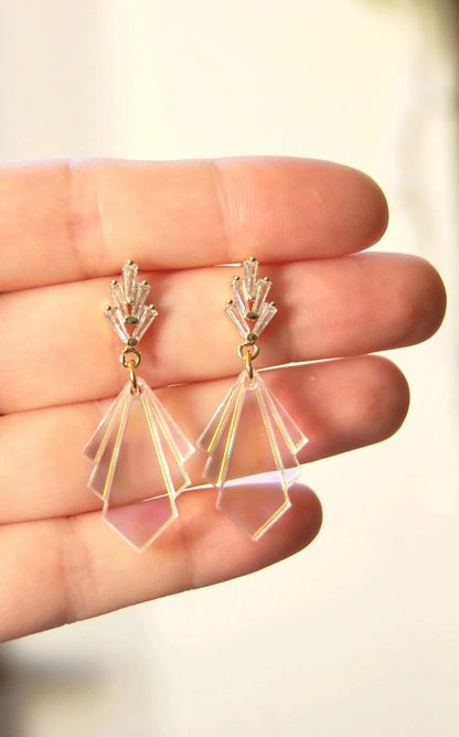 Photo shows the product being held in a hand. Earrings have 5 rectangular cubic zirconia stones in a fan at the post, and has a fan in an acrylic iridescent style for the bottom of the earrings