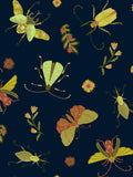This photo showcases the print of the shorts. It is various greens, yellows, and gold colored insects including moths, and beetles. It also includes flowers in the same color scheme